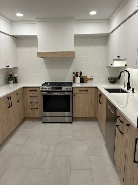 110 S Dunton Ave Unit 4G, Arlington Heights, IL 60005 - kitchen featuring appliances with stainless steel finishes, tasteful backsplash, light countertops, and recessed lighting