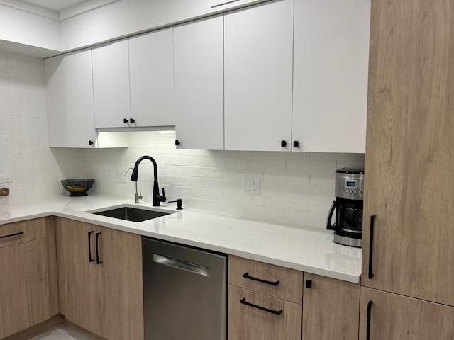 110 S Dunton Ave Unit 4G, Arlington Heights, IL 60005 - kitchen featuring dishwasher, backsplash, light countertops, and white cabinetry