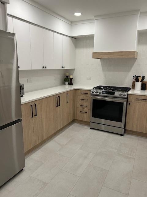 110 S Dunton Ave Unit 4G, Arlington Heights, IL 60005 - kitchen with appliances with stainless steel finishes, light countertops, exhaust hood, white cabinetry, and light flooring