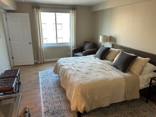 110 S Dunton Ave Unit 4G, Arlington Heights, IL 60005 - bedroom featuring wood finished floors and baseboards