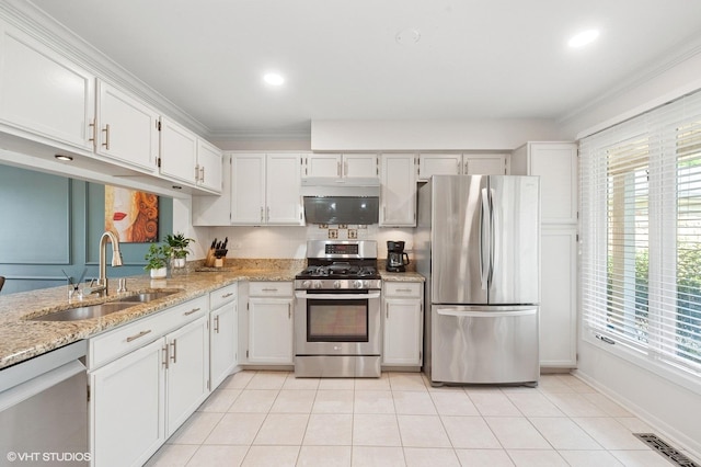 336 Redwing Dr Unit 18-3, Deerfield, IL 60015 - kitchen featuring appliances with stainless steel finishes, white cabinets, light stone countertops, crown molding, and light tile patterned flooring