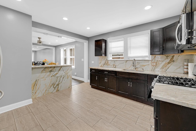 5424 N Lotus Ave, Chicago, IL 60630 - kitchen with stainless steel microwave, decorative backsplash, recessed lighting, and dark brown cabinets