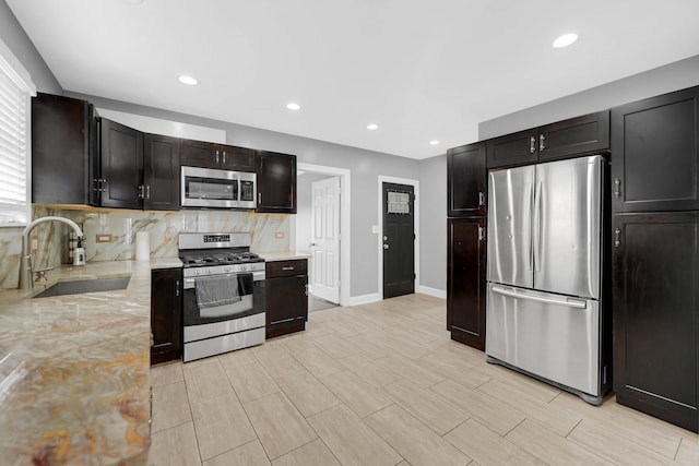 5424 N Lotus Ave, Chicago, IL 60630 - kitchen featuring stainless steel appliances, tasteful backsplash, light stone counters, and recessed lighting