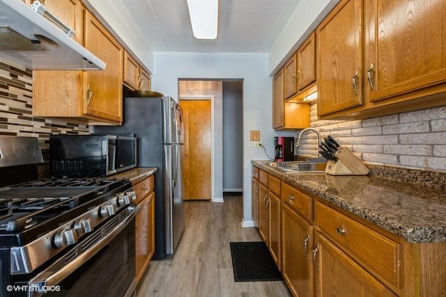 6530 W 94th Pl Unit 2A, Oak Lawn, IL 60453 - kitchen featuring stainless steel appliances, under cabinet range hood, brown cabinetry, and backsplash