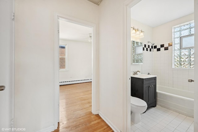 2424 W Farragut Ave Unit 3B, Chicago, IL 60625 - full bathroom with baseboard heating, vanity, healthy amount of natural light, and shower / tub combination