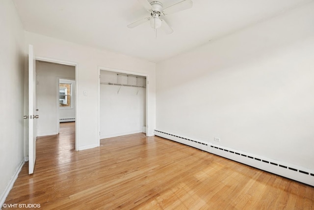 2424 W Farragut Ave Unit 3B, Chicago, IL 60625 - unfurnished bedroom with baseboard heating, light wood-style floors, a closet, and a ceiling fan