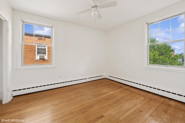 2424 W Farragut Ave Unit 3B, Chicago, IL 60625 - spare room featuring wood finished floors, baseboard heating, and a ceiling fan