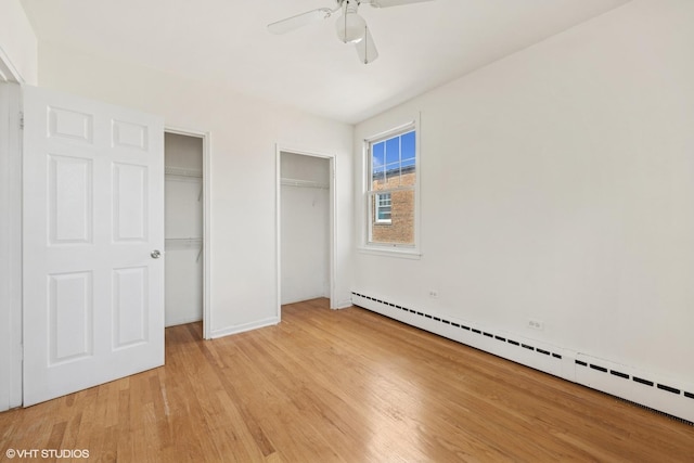 2424 W Farragut Ave Unit 3B, Chicago, IL 60625 - unfurnished bedroom with a baseboard heating unit, two closets, light wood finished floors, and ceiling fan