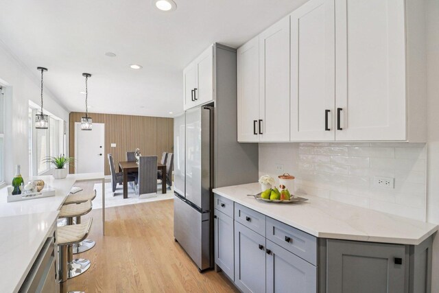 7248 N Kildare Ave, Lincolnwood, IL 60712 - kitchen featuring gray cabinets, freestanding refrigerator, light wood-type flooring, recessed lighting, and tasteful backsplash