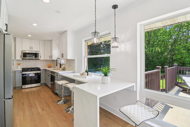 7248 N Kildare Ave, Lincolnwood, IL 60712 - kitchen featuring appliances with stainless steel finishes, light countertops, tasteful backsplash, white cabinetry, and light wood-style floors