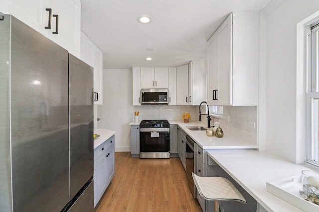 7248 N Kildare Ave, Lincolnwood, IL 60712 - kitchen featuring appliances with stainless steel finishes, light wood finished floors, tasteful backsplash, light countertops, and recessed lighting