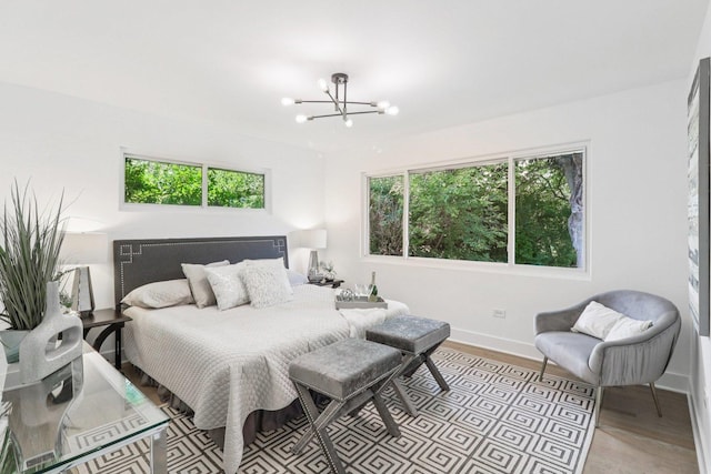 7248 N Kildare Ave, Lincolnwood, IL 60712 - bedroom with multiple windows, a chandelier, and light wood-type flooring