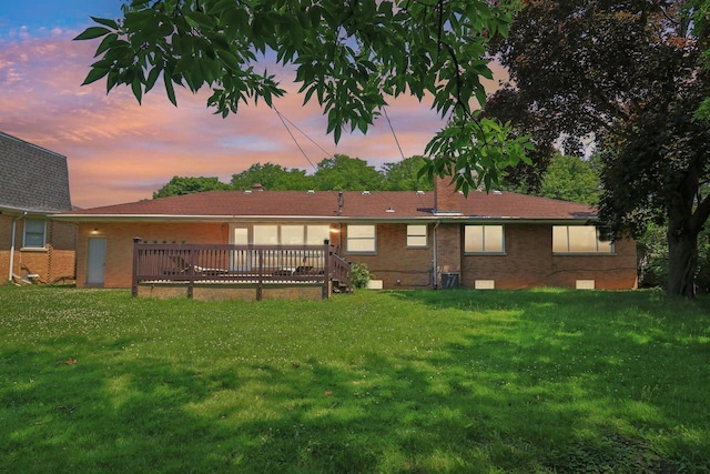 7248 N Kildare Ave, Lincolnwood, IL 60712 - rear view of property featuring brick siding, a yard, and a wooden deck