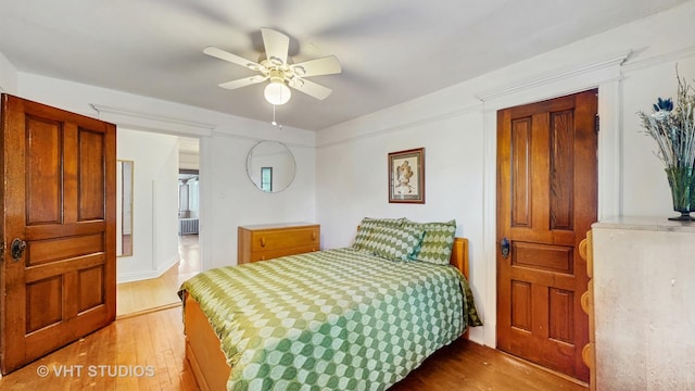 1320 Oak Park Ave, Berwyn, IL 60402 - bedroom featuring wood-type flooring, radiator heating unit, and ceiling fan