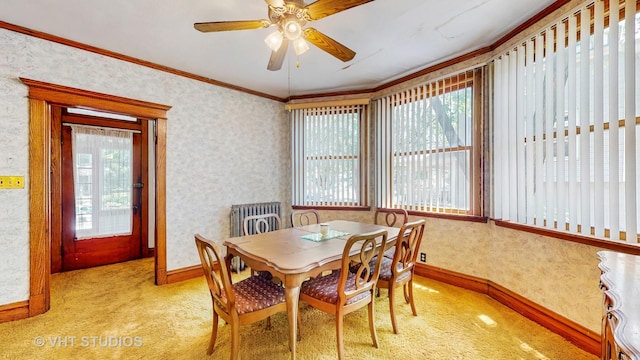 1320 Oak Park Ave, Berwyn, IL 60402 - dining space featuring light colored carpet, crown molding, ceiling fan, and wallpapered walls