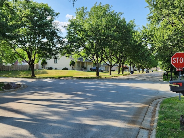 9410 S 77th Ct Unit 3F, Hickory Hills, IL 60457 - view of asphalt road featuring curbs and traffic signs
