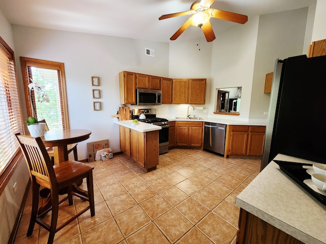 9410 S 77th Ct Unit 3F, Hickory Hills, IL 60457 - kitchen with appliances with stainless steel finishes, brown cabinetry, light countertops, a peninsula, and high vaulted ceiling