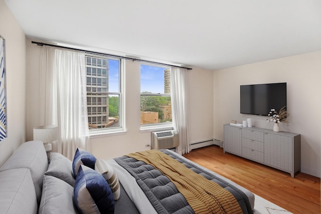3033 N Sheridan Rd Unit 603, Chicago, IL 60657 - bedroom with wood finished floors, a baseboard heating unit, and an AC wall unit