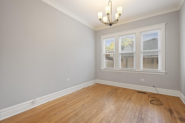 2713 W 24th Pl, Chicago, IL 60608 - unfurnished room with a chandelier, crown molding, and light wood finished floors