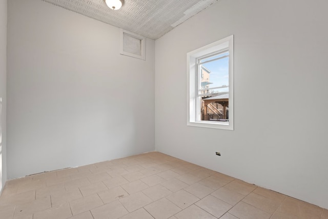 2713 W 24th Pl, Chicago, IL 60608 - empty room featuring an ornate ceiling and light tile patterned floors