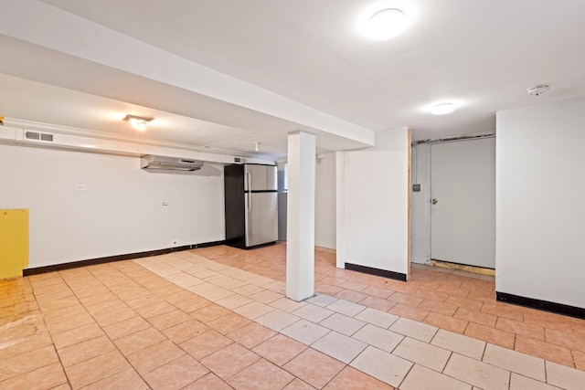 2713 W 24th Pl, Chicago, IL 60608 - finished basement with freestanding refrigerator, a wall unit AC, and light tile patterned flooring