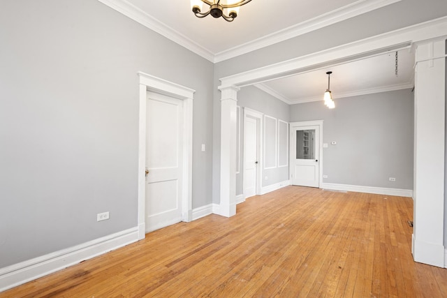 2713 W 24th Pl, Chicago, IL 60608 - empty room featuring light wood-style floors, a chandelier, crown molding, and decorative columns
