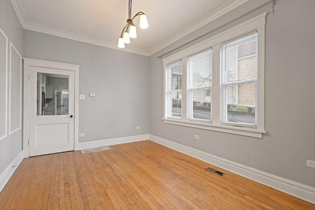 2713 W 24th Pl, Chicago, IL 60608 - spare room featuring ornamental molding and light wood finished floors