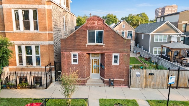 2713 W 24th Pl, Chicago, IL 60608 - view of front of home featuring brick siding, a gate, entry steps, and a gazebo