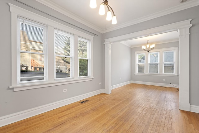 2713 W 24th Pl, Chicago, IL 60608 - empty room featuring a chandelier, light wood-type flooring, crown molding, and ornate columns