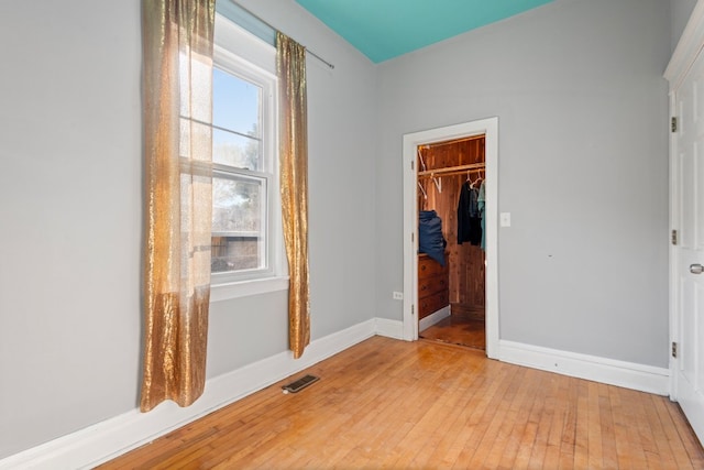 2713 W 24th Pl, Chicago, IL 60608 - unfurnished bedroom featuring light wood-style flooring, a walk in closet, and a closet