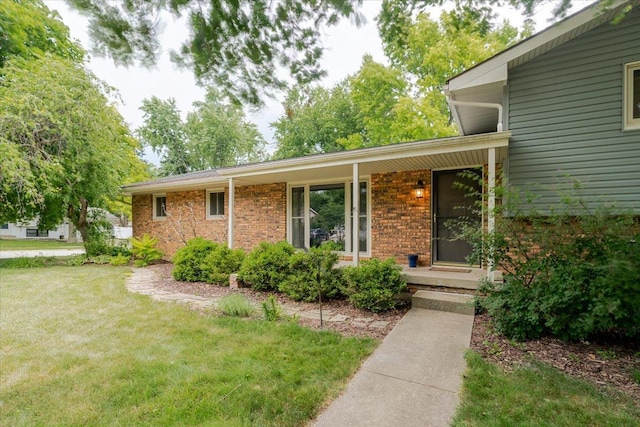 106 Sandra Ln, Normal, IL 61761 - view of front of house featuring a porch, a front lawn, and brick siding