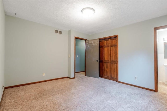 106 Sandra Ln, Normal, IL 61761 - unfurnished bedroom with carpet, a closet, a textured ceiling, and ensuite bathroom