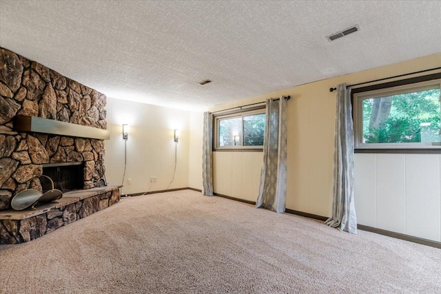 106 Sandra Ln, Normal, IL 61761 - unfurnished living room with a textured ceiling, carpet floors, and a fireplace