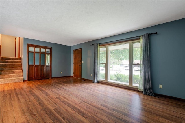 106 Sandra Ln, Normal, IL 61761 - unfurnished living room featuring wood finished floors and stairway