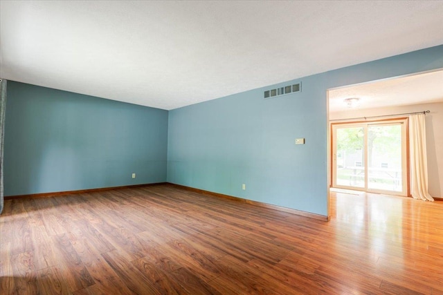 106 Sandra Ln, Normal, IL 61761 - empty room featuring wood finished floors and baseboards