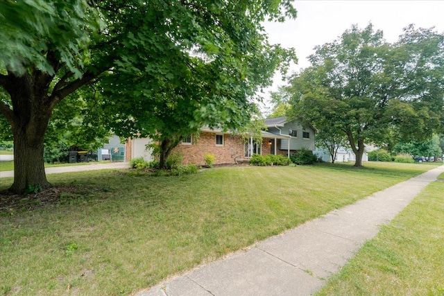 106 Sandra Ln, Normal, IL 61761 - view of front of house with brick siding, a front lawn, a garage, and driveway