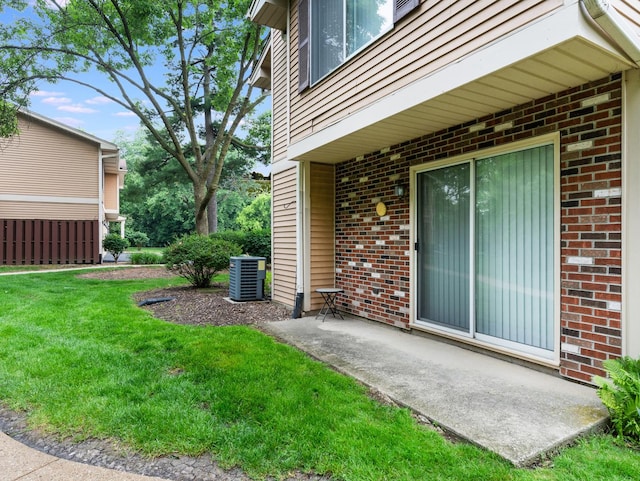 33 E Hickory St Unit A, Lombard, IL 60148 - doorway to property featuring a yard, brick siding, and a patio area