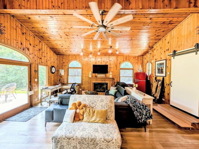 1274 N Cooper Rd, New Lenox, IL 60451 - living room featuring vaulted ceiling, plenty of natural light, a barn door, wooden ceiling, and light wood-style floors