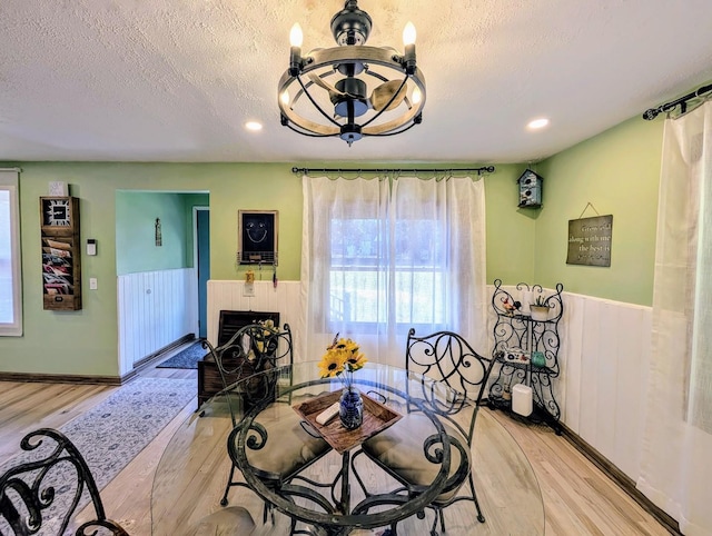 1274 N Cooper Rd, New Lenox, IL 60451 - dining area with light wood-style floors, a wainscoted wall, a chandelier, a textured ceiling, and recessed lighting