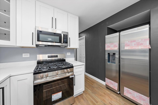7133 S Honore St, Chicago, IL 60636 - kitchen with stainless steel appliances, white cabinets, light wood-type flooring, and glass insert cabinets