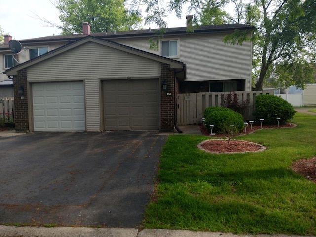 853 Greenbriar Ln, University Park, IL 60484 - traditional-style house with asphalt driveway, a garage, and brick siding