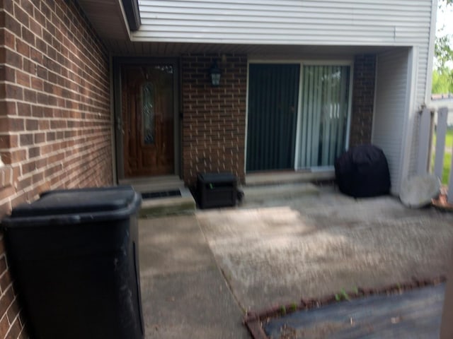 853 Greenbriar Ln, University Park, IL 60484 - doorway to property with brick siding and a patio area