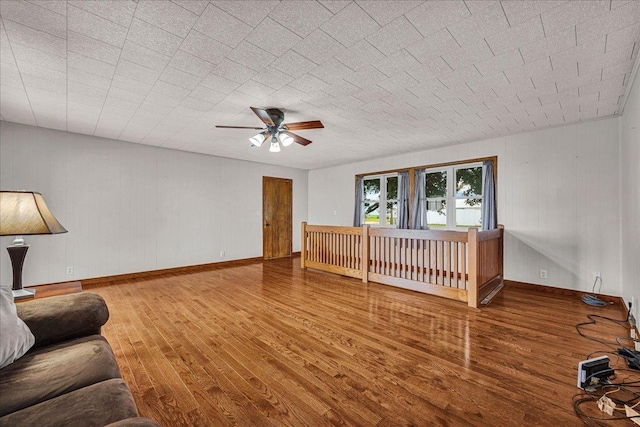 708 N 1950th Rd, Tonica, IL 61370 - unfurnished living room with wood finished floors and a ceiling fan