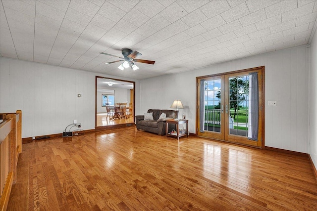708 N 1950th Rd, Tonica, IL 61370 - living room featuring wood finished floors, ceiling fan, and wood walls