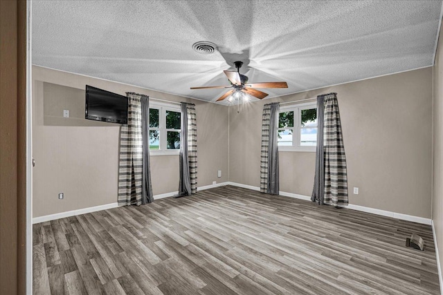 708 N 1950th Rd, Tonica, IL 61370 - empty room featuring a ceiling fan, wood finished floors, and a textured ceiling