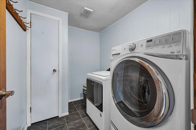 708 N 1950th Rd, Tonica, IL 61370 - laundry room with washer and dryer, dark tile patterned flooring, and a textured ceiling