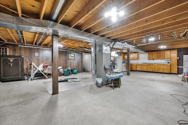 708 N 1950th Rd, Tonica, IL 61370 - unfinished basement with wooden walls and freestanding refrigerator