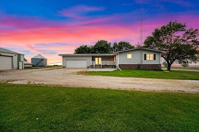 708 N 1950th Rd, Tonica, IL 61370 - ranch-style home featuring dirt driveway, a yard, and an attached garage