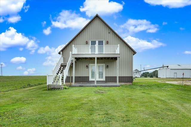 708 N 1950th Rd, Tonica, IL 61370 - rear view of house with board and batten siding, french doors, a lawn, and stairway