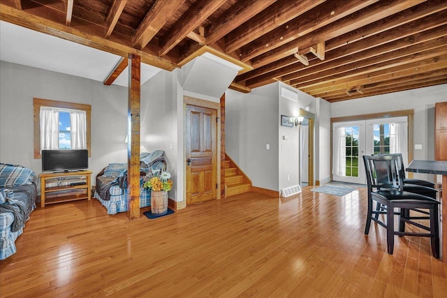708 N 1950th Rd, Tonica, IL 61370 - living area with french doors, plenty of natural light, light wood finished floors, stairway, and beamed ceiling